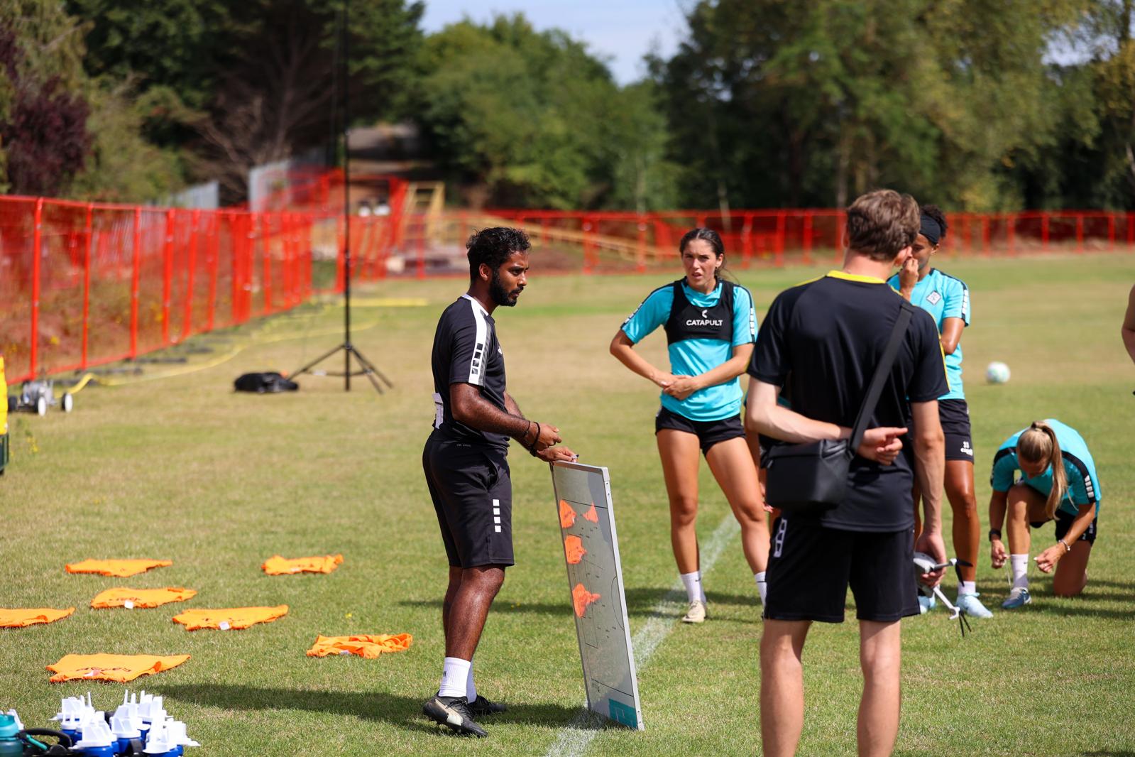 Coach delivering a coaching consultancy session with players